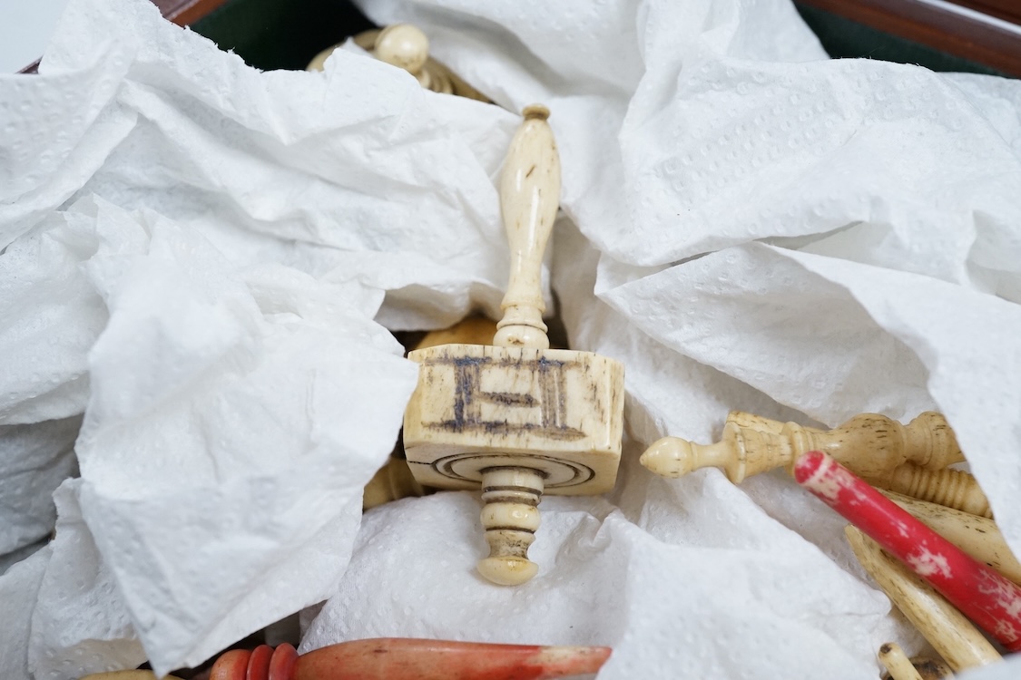 A collection of 19th century bone or coquille nut teetotum gaming spinners or twirlers and gaming items, in a leather box